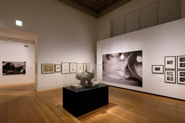 Ausstellungsraum mit Statue und Bildern